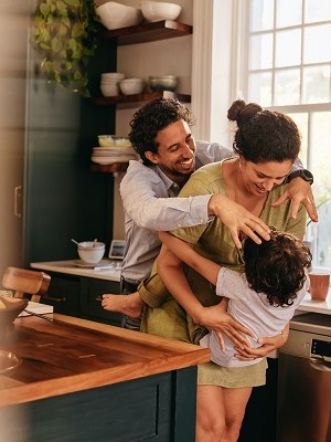 Parents playing with their son in the kitchen