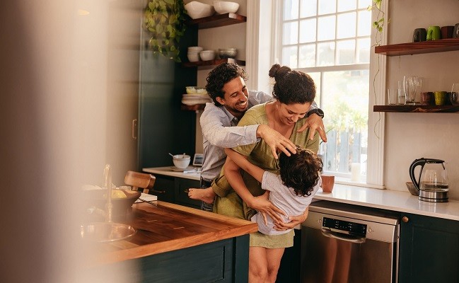 Parents playing with their son in the kitchen