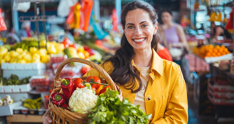 Smiling Woman Shopping Fresh Vegetables at a Bustling Farmers Market